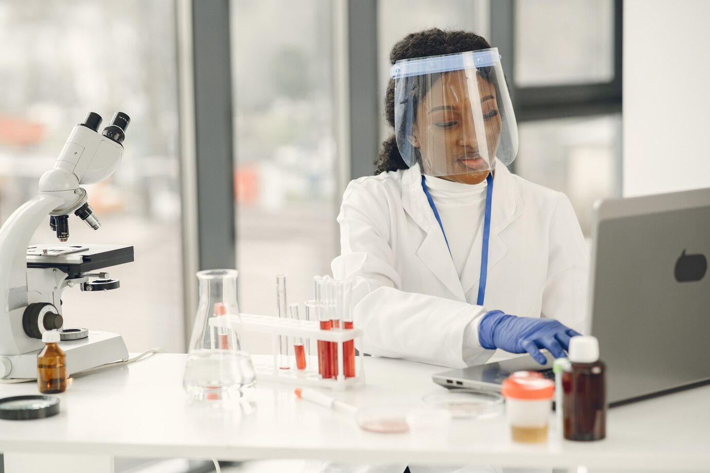 laboratory-research-blood-coronavirus-concept-afrcican-woman-inspecting-blood-using-laptop_1157-48132