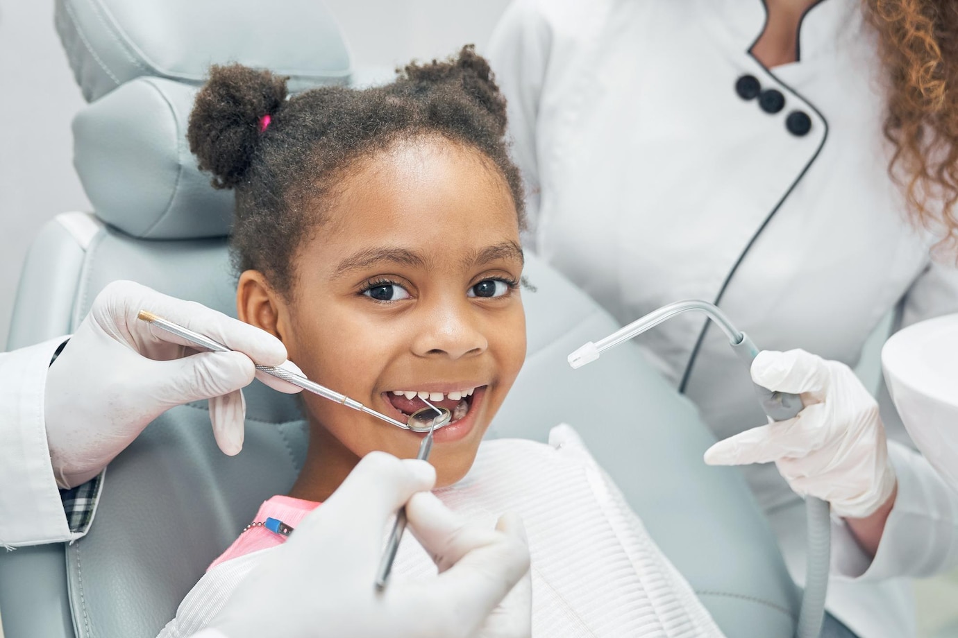 happy-afro-kid-regular-check-up-teeth-dental-clinic_651396-1411